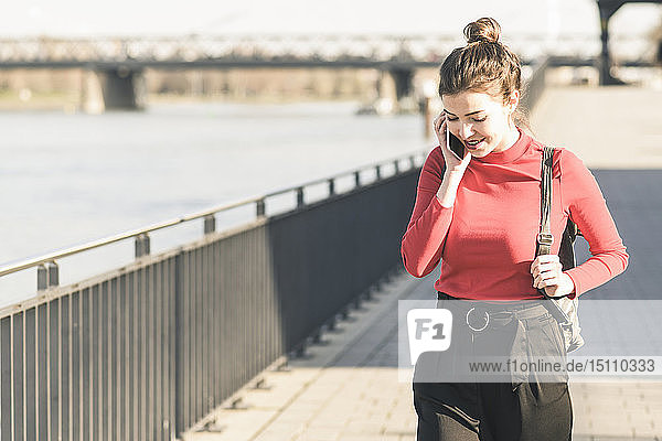 Young woman on the phone in the city