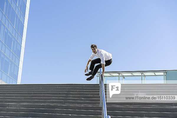 Businessman crossing banister in the city