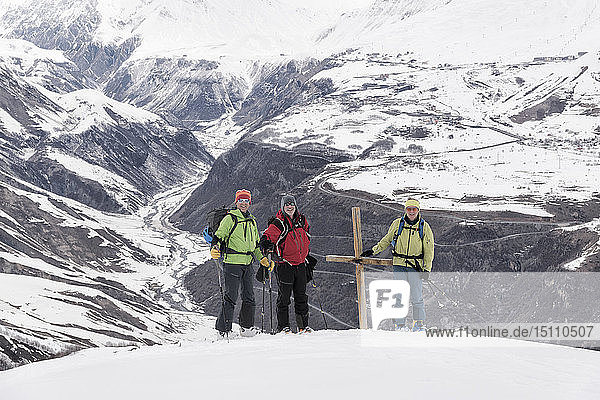 Georgia  Caucasus  Gudauri  peeope at summit cross on a ski tour to Lomisi Monastery