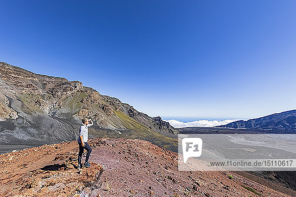 Tourist enjoying view from Sliding Sands Trail  Haleakala volcano  Haleakala National Park  Maui  Hawaii  USA