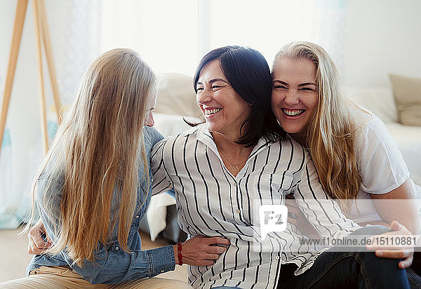 Visiting daughters embracing their mother
