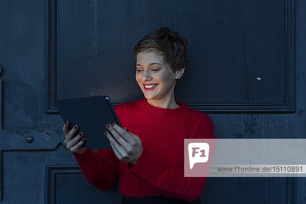 Portrait of smiling businesswoman using digital tablet at twilight