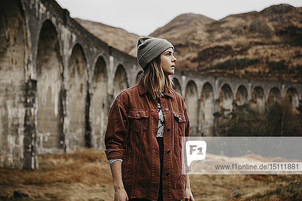 UK  Scotland  Highland  portrait of young woman at Glenfinnan Viaduct