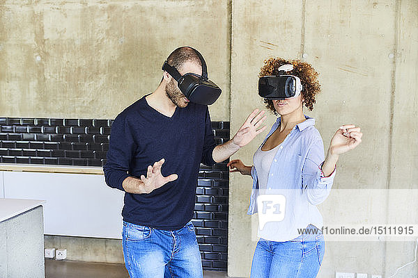 Man and woman wearing VR glasses moving