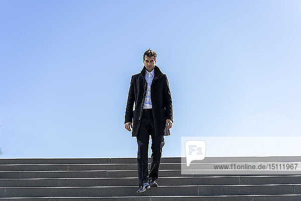 Businessman walking down stairs