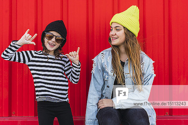 Portrait of teenage girl having fun with younger sister