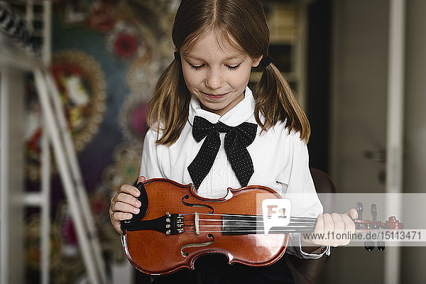 Girl looking at her violin