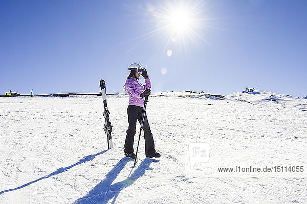 Woman wearing ski clothing getting ready to ski at the Sierra Nevada  Andalusia  Spain