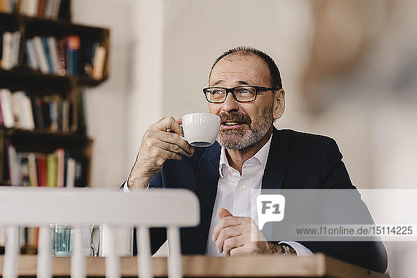 Mature businessman having a coffee in a cafe