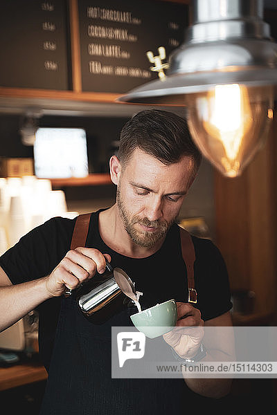 Barista preparing a coffee in coffee shop