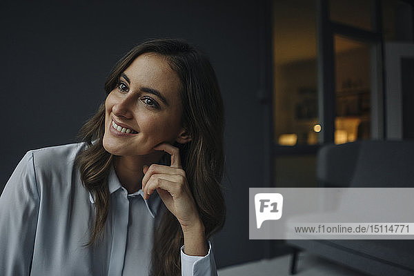 Portrait of smiling young businesswoman looking sideways