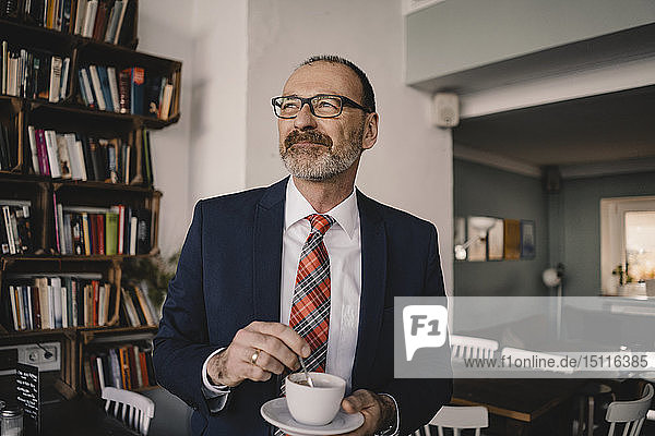Mature businessman in a cafe with cup of coffee