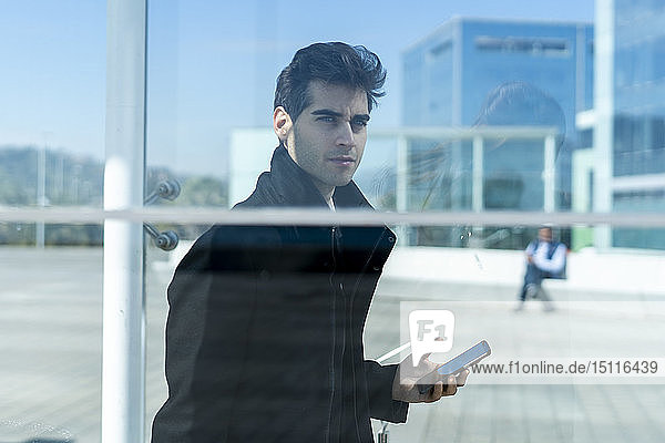 Businessman with cell phone in the city