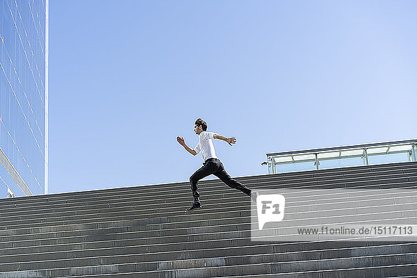 Businessman running on stairs in the city