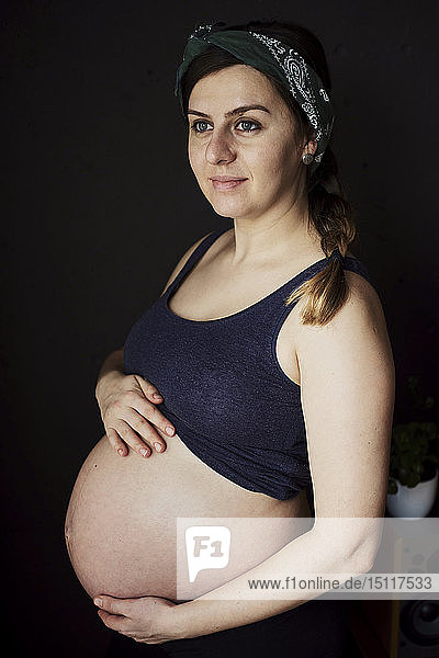 Schwangere Frau hält ihren Babybauch