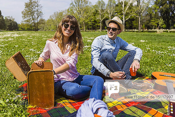 Young couple having a picnic with healthy food in a park