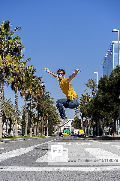 Spain  Barcelona  man in the city jumping on the street
