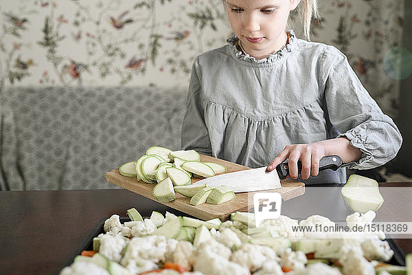 Girl slicing vegetables