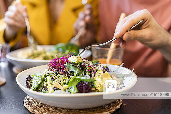 Close-up of people having healthy lunch in a restaurant