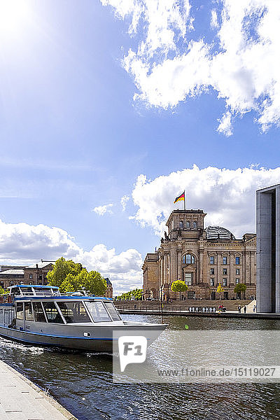 View to Reichstag with tourboat on Spree River in the foreground  Berlin  Germany