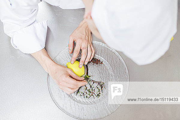 Junior chef prepairing a dessert plate