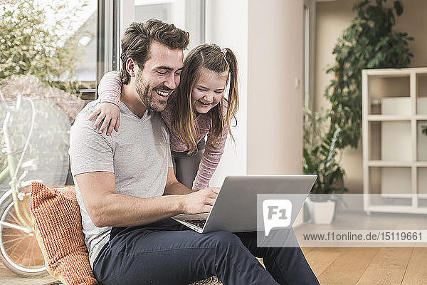 Young man and little girl surfing the net together