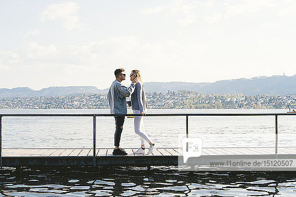 Young couple in love standing on jetty at Lake Zurich  Zurich  Switzerland