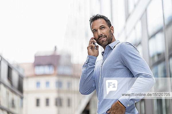 Businessman on cell phone in the city