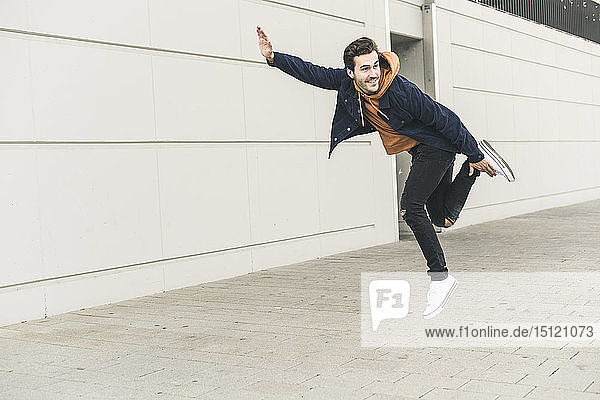 Young man jumping in the street  pretending to fly