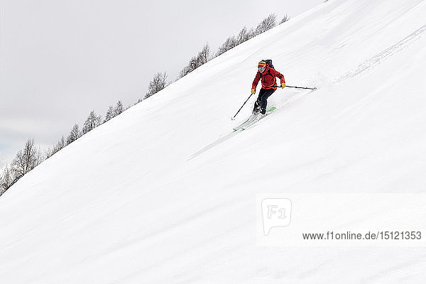 Georgia  Caucasus  Gudauri  man on a ski tour riding downhill