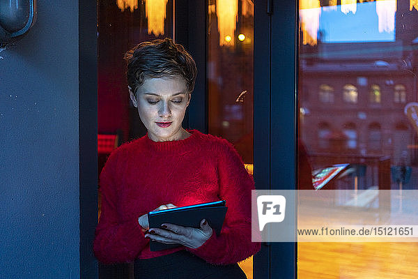 Germany  Berlin  portrait of businesswoman using digital tablet outdoors