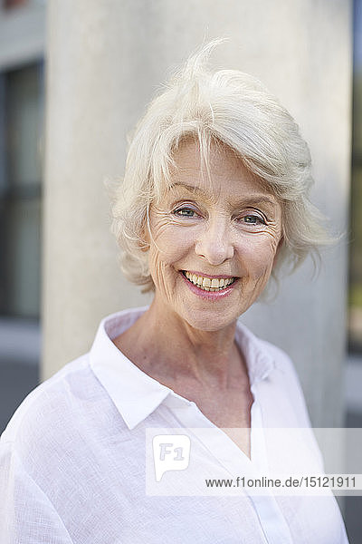 Portrait of smiling mature woman with blowing hair