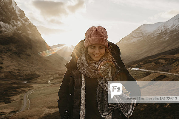 UK  Scotland  Highlands  smiling young woman in rural landscape