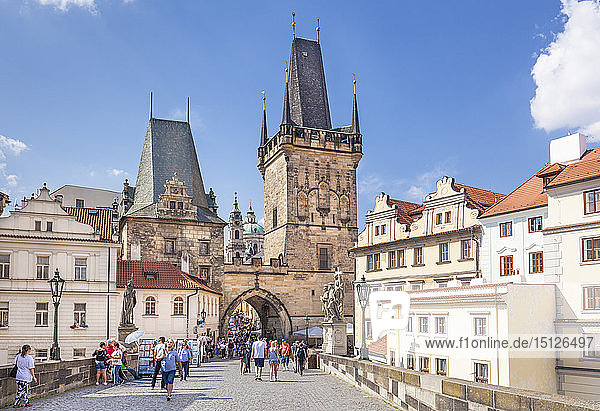 The Lesser Town Bridge Tower of Charles Bridge with people visiting the Mala Strana district  UNESCO World Heritage Site  Prague  Czech Republic  Europe