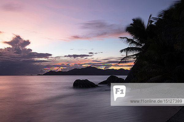 Sunset at Anse Source d'Argent looking toward Praslin Union Estate Park La Digue Seychelles Indian Ocean Africa