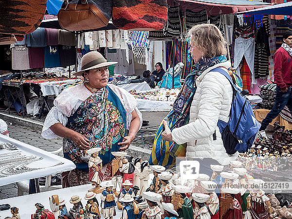Tourist shopping at market  Plaza de los Ponchos  Otavalo  Ecuador  South America