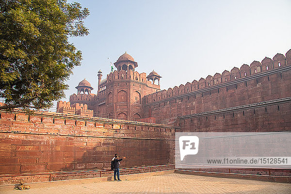 A couple take a selfie while a dog sunbathes at The Red Fort  UNESCO World Heritage Site  Old Delhi  India  Asia