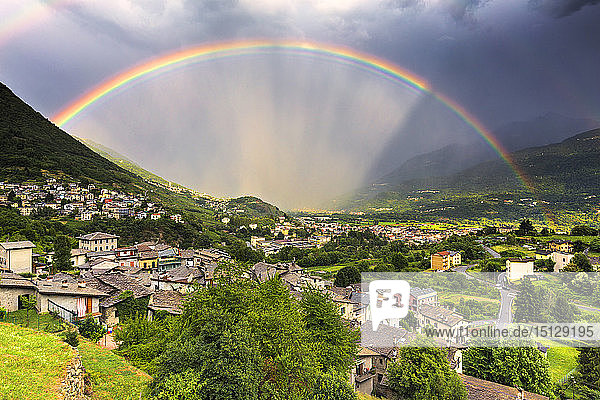 Rainbow above the valley Valtellina Lombardy Italy Europe