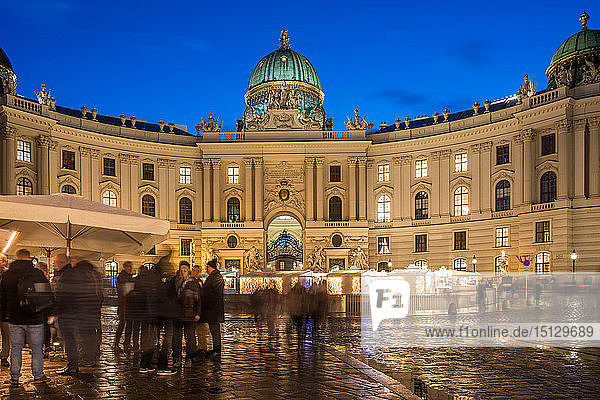 Christmas market on Michaelerplatz with Hofburg Palace at dusk  Vienna  Austria  Europe