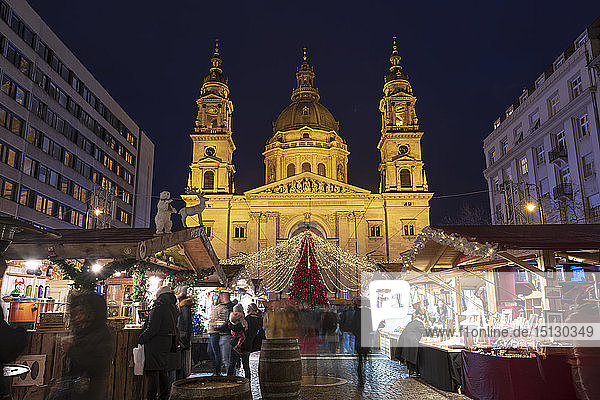 Christmas stalls at night in front of St. Stephen's Basilica in Budapest  Hungary  Europe