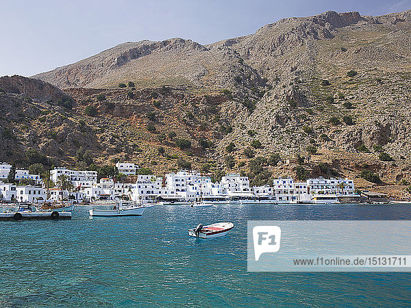 View across the clear turquoise waters of the harbour  Loutro  Hania (Chania)  Crete  Greek Islands  Greece  Europe