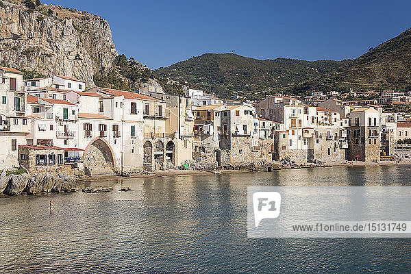 View across harbour to the Old Town  houses clustered together along waterfront  Cefalu  Palermo  Sicily  Italy  Mediterranean  Europe