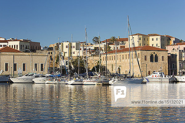 View across the Old Harbour  early morning  quayside buildings reflected in water  Hania (Chania)  Crete  Greek Islands  Greece  Europe