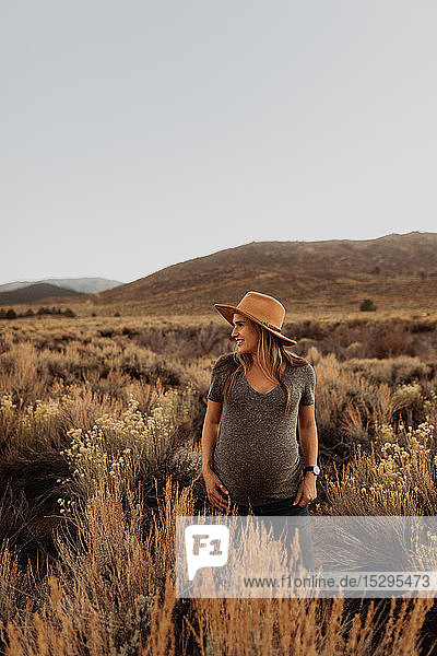 Pregnant woman in field landscape  Kennedy Meadows  California  US