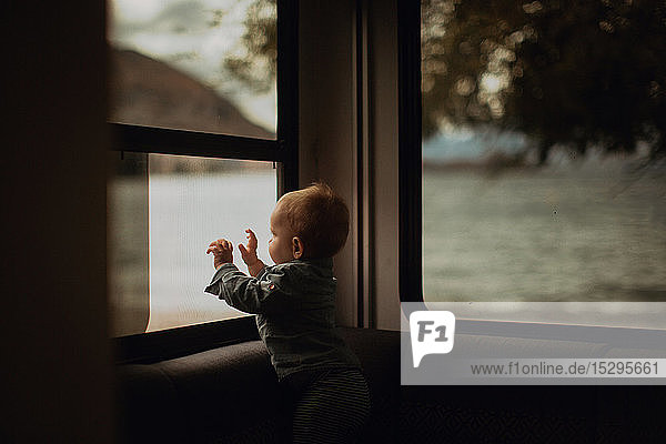 Baby schaut aus dem Fenster eines Wohnmobils  Wanaka  Taranaki  Neuseeland
