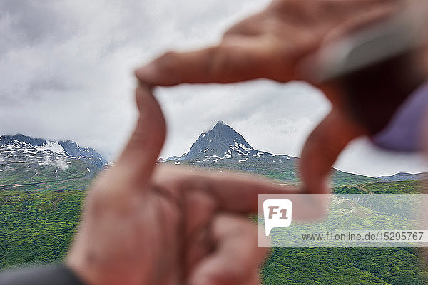 Älterer Mann und Sohn umrahmen Berggipfel mit den Händen  Nahaufnahme  Valdez  Alaska  USA