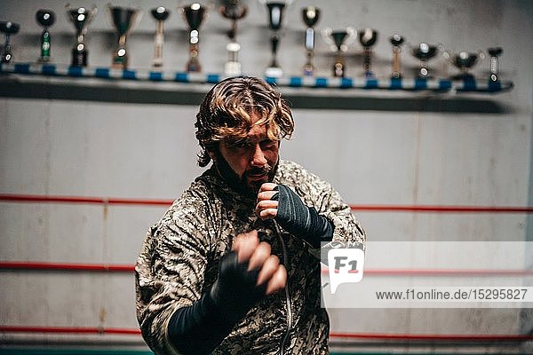 Boxer training in boxing ring