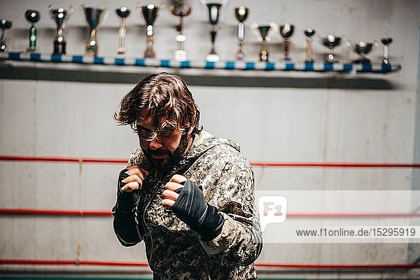Boxer training in boxing ring