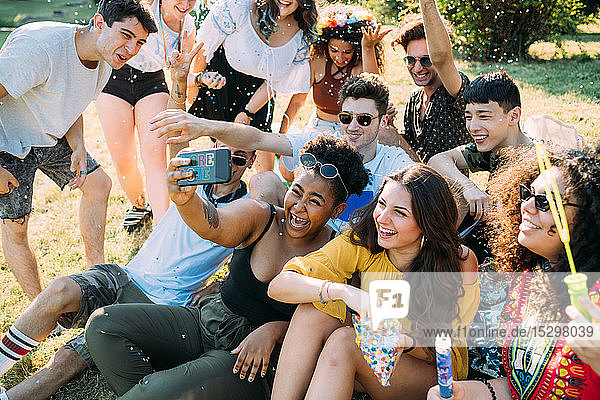 Group of friends taking selfie in park
