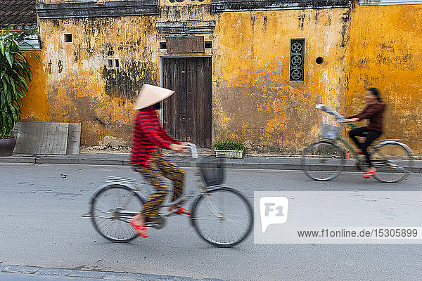 Cyclists on a street in Hoi An  Vietnam.